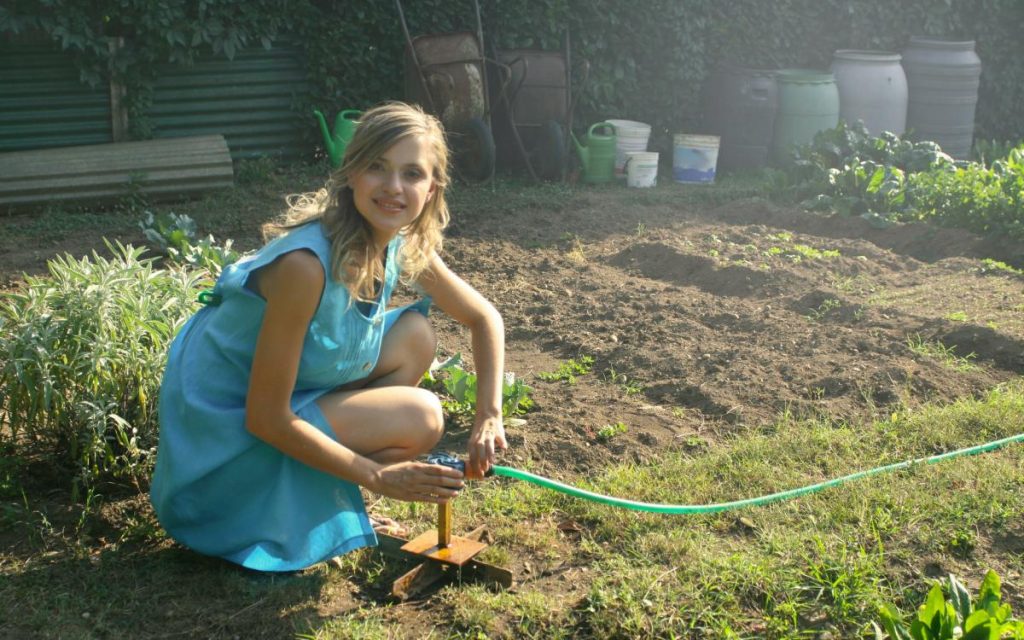 Woman Watering Allotment Garden